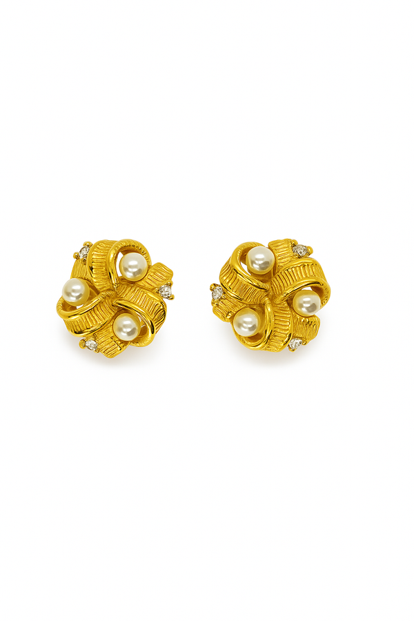 Gold textured ribbon stud earrings with pearls and diamond accents on white background