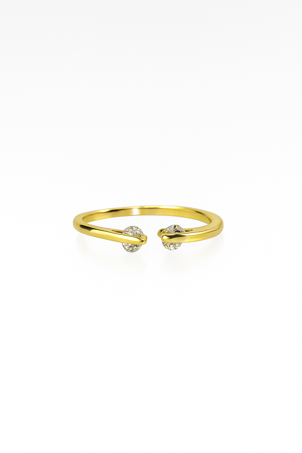 Gold open cuff ring with diamond accents on white background