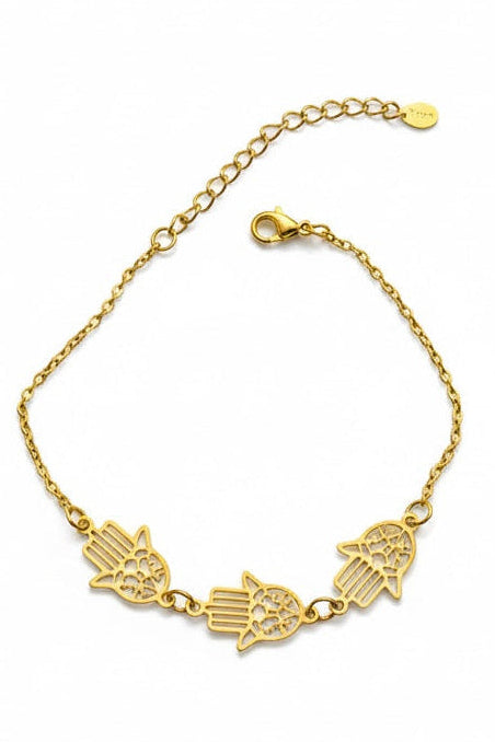 Gold bracelet with hamsa hand design on a white background